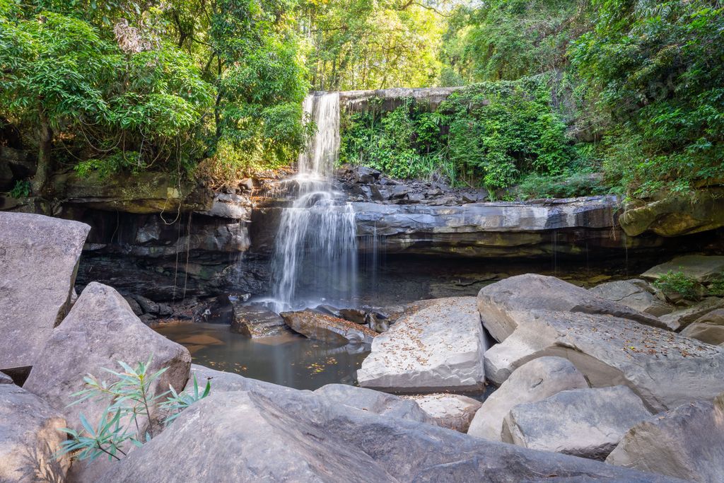The foamy Huang Nam Keaw Waterfall in Koh Kood, Thailand surrounded by the green trees