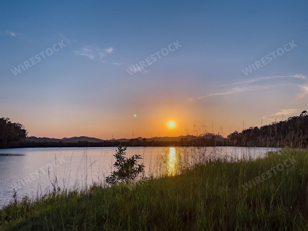 A beautiful view of a calm lake at scenic sunset