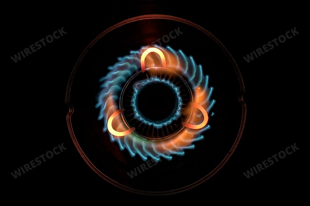 An aerial shot of a beautiful blue-green flame in the gas stove