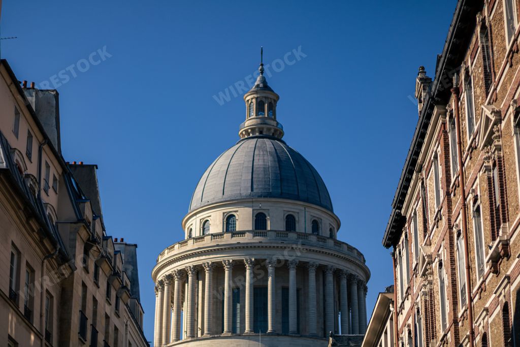 A low-angle shot of the Pantheon of Paris before the blue skyline