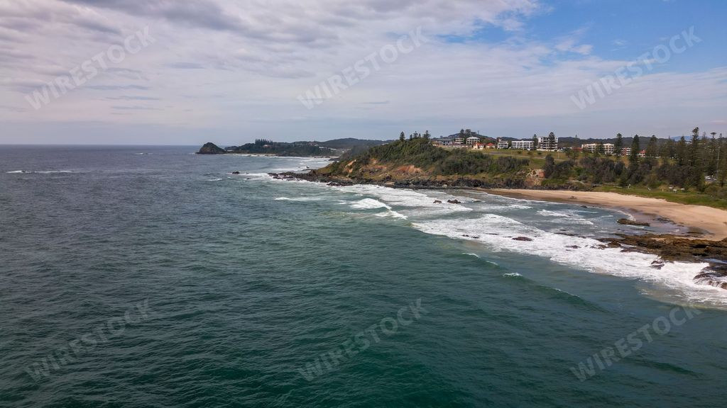 A beautiful view of Oxley Beach in Port Macquarie with dark blue water moving to the sandy coast