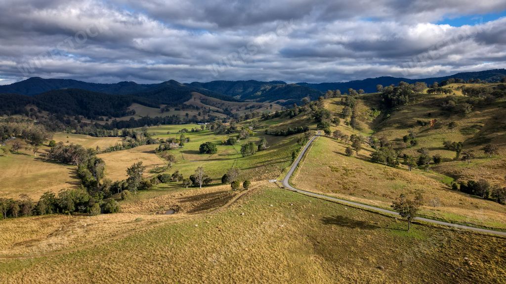 A high-angle shot of tree covered landscape and fields in Australia