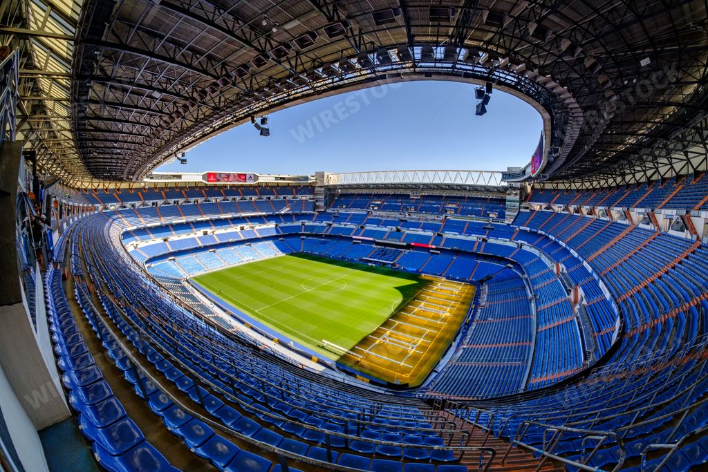A high-angle, aerial shot of the Santiago Bernabeu stadium in Madrid, Spain, on a sunny day