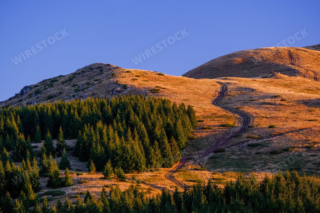 The landscape of Stara Planina Mountain at a soft orange sunset