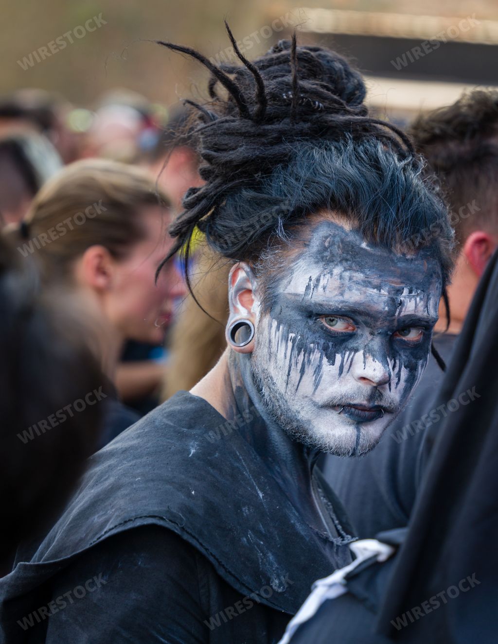 A vertical shot of a person in face paint at the Brutal Assault 2022 festival in Jaromer