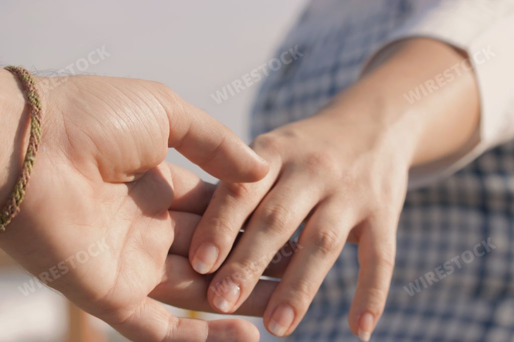 A closeup shot of a couple holding hands together