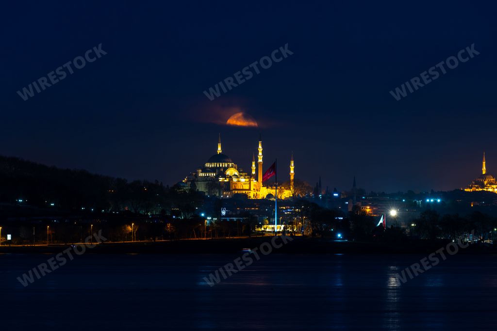 A stunning view of the majestic Blue Mosque in Istanbul, Turkey illuminated by a bright night sky