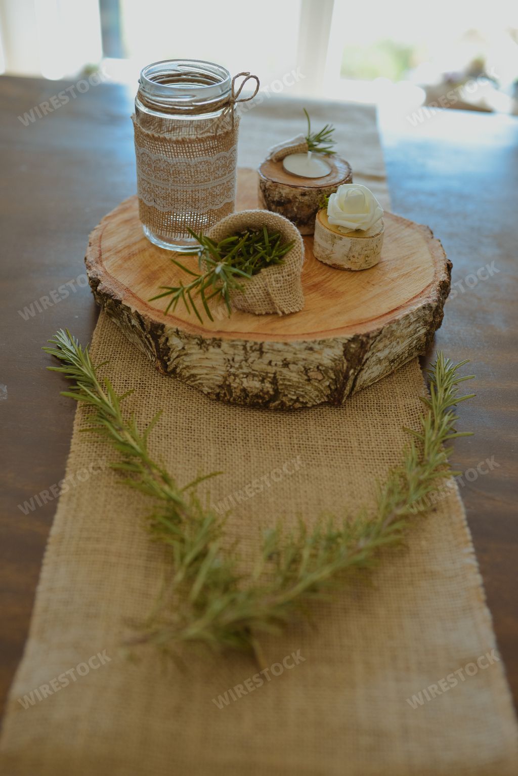 A selective focus shot of eco-style wedding decorations on a small wooden stump