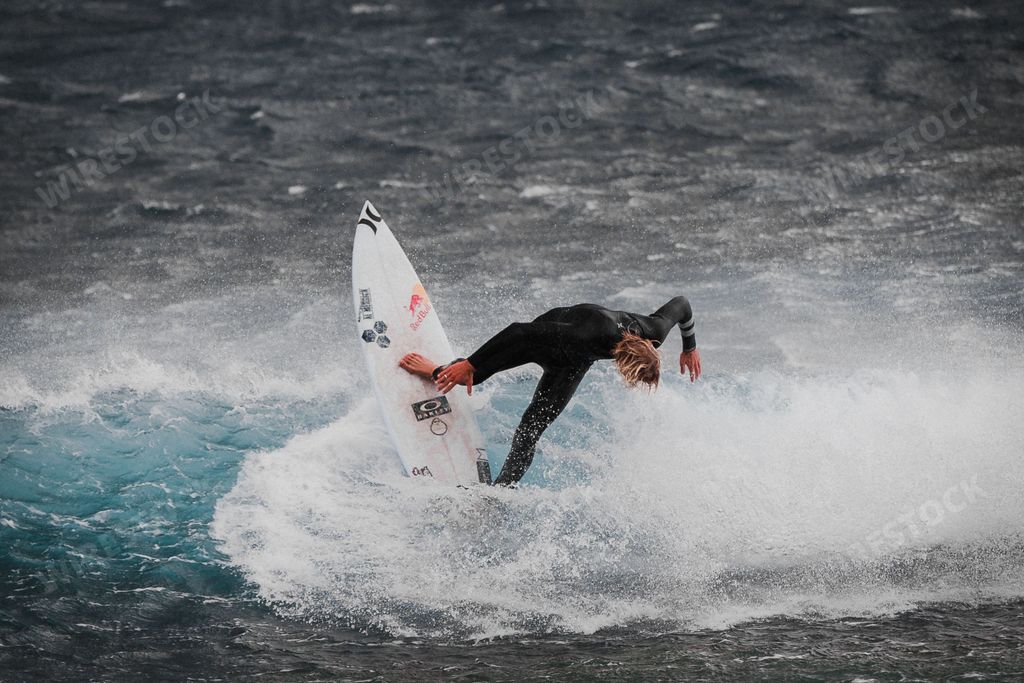 A stunning view of a surfer catches a wave