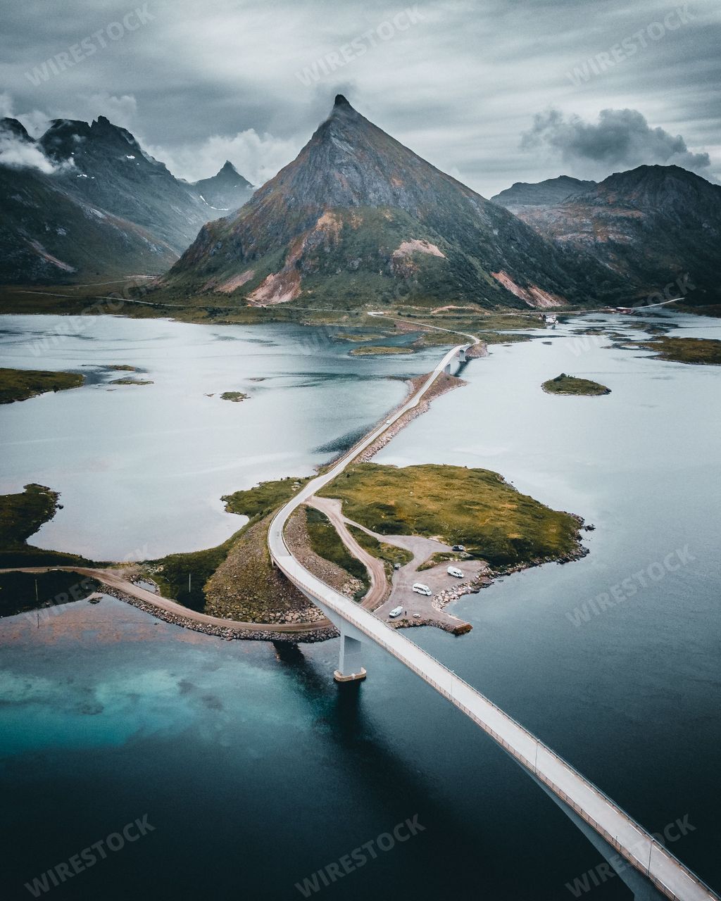 A vertical shot of Fredvang Bridges surrounded by rocky hills in Norway