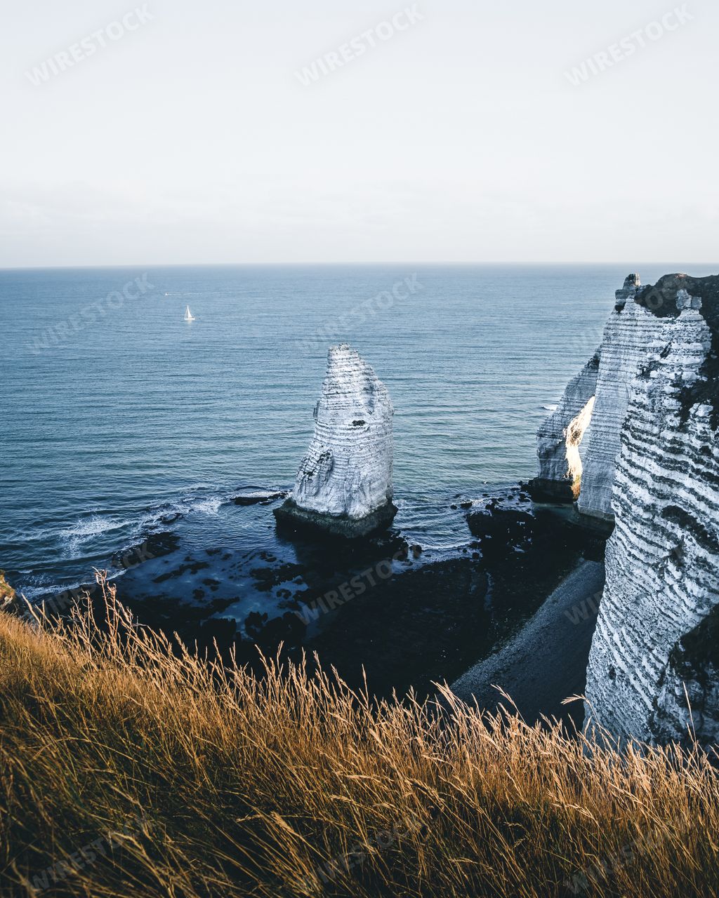 A vertical shot of famous chalk cliffs at Alabaster Coast in Etretat, France