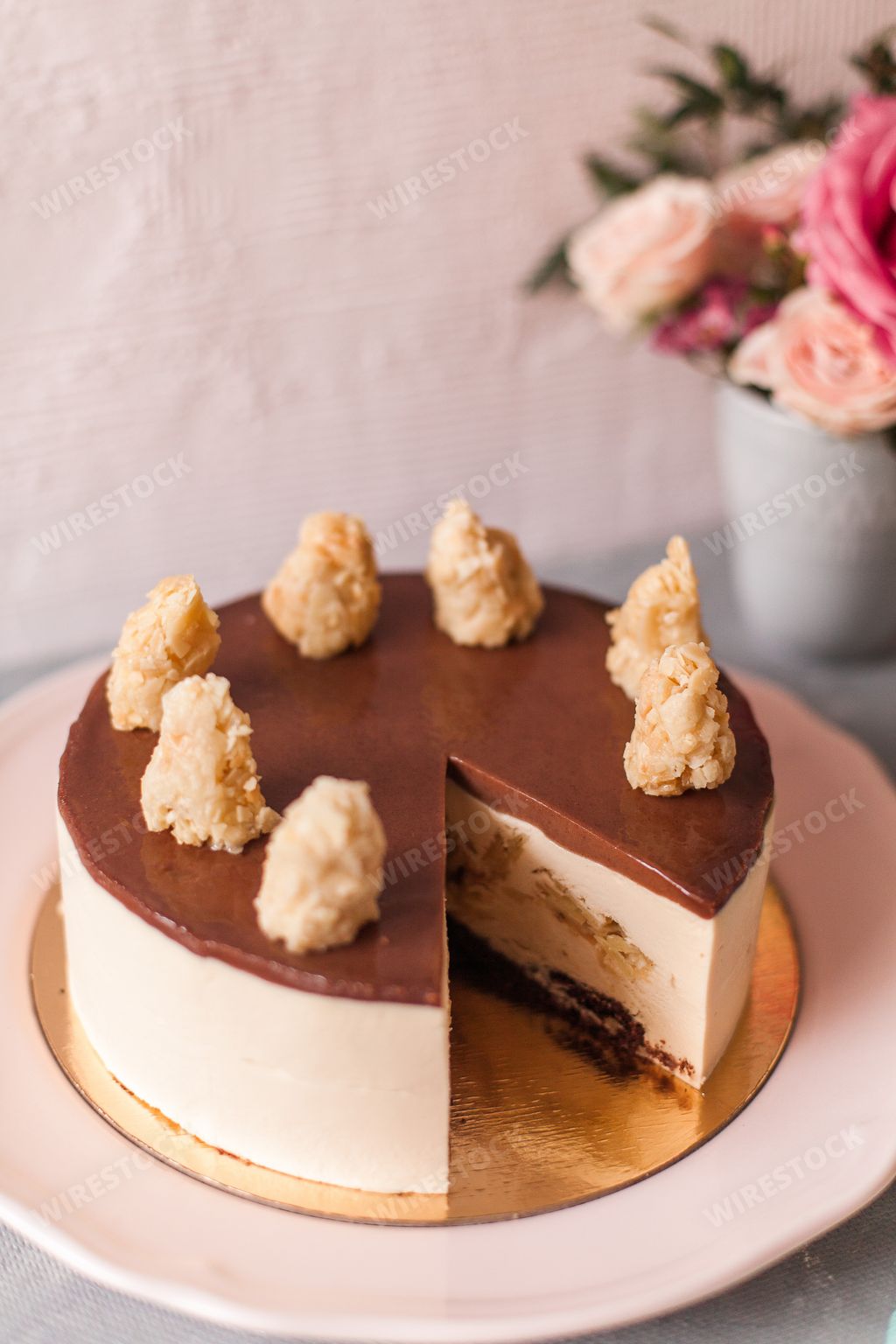 An aesthetic shot of a chocolate cheesecake arranged with delicate flowers
