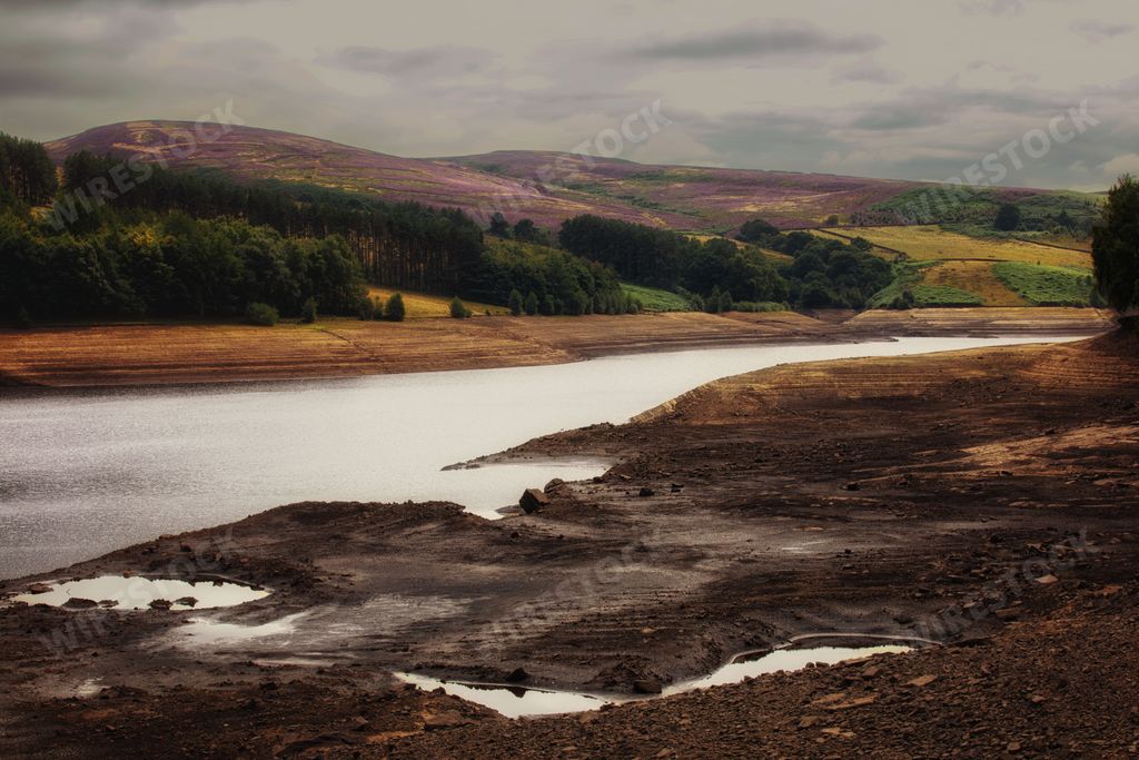 The view of the river and hills with green vegetation. Errwood Reservoir. Peak District National Park.