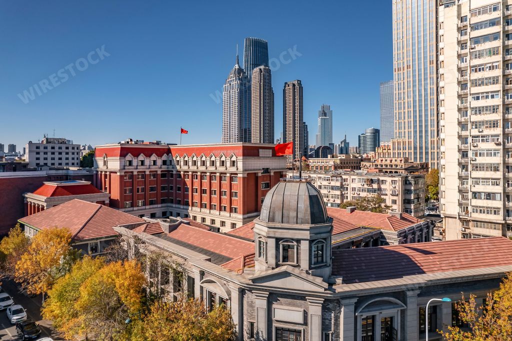 A high-angle view of city full of skyscrapers under the blue sky.