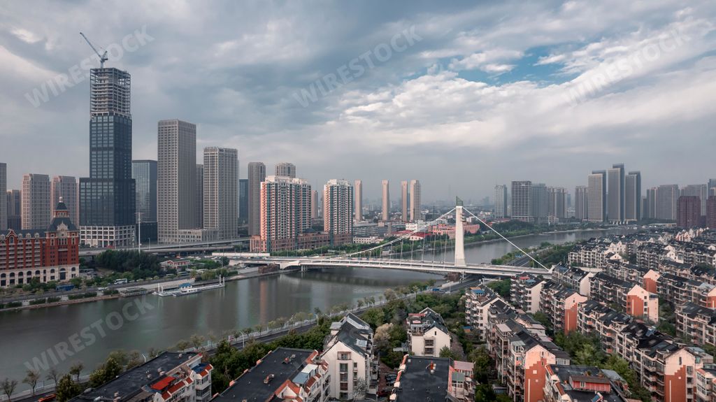 Aerial photos of Haijin Bridge and Fumin Bridge along the Haihe River in Tianjin, China and their connecting surroundings.