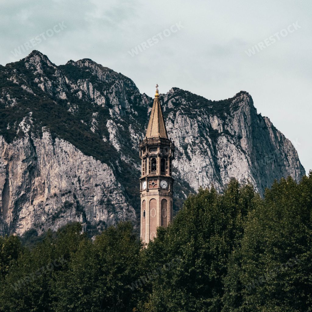 The ancient tower of San Nicolo against the mountain and clouds