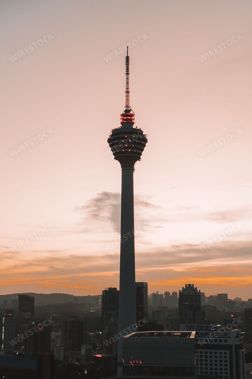 A vertical shot of the silhouette of Menara Tower in Kuala Lumpur during the sunset