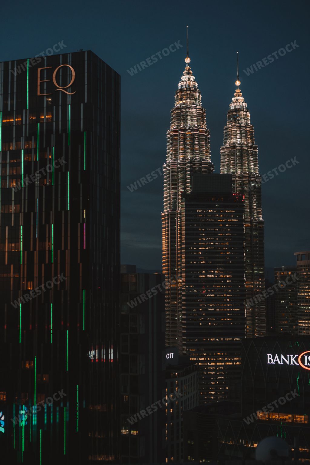 A landscape of illuminating Petronas Twin towers during sunset in city center, vertical shot
