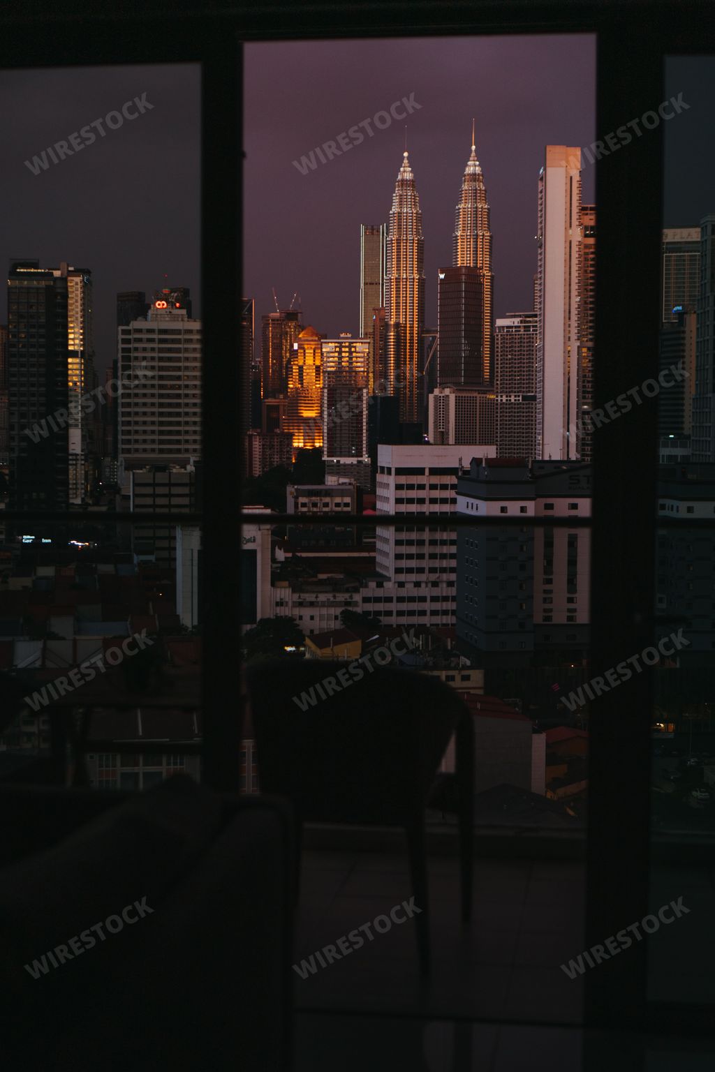 A vertical shot of modern buildings in the city center of Kuala Lumpur seen from a panoramic window