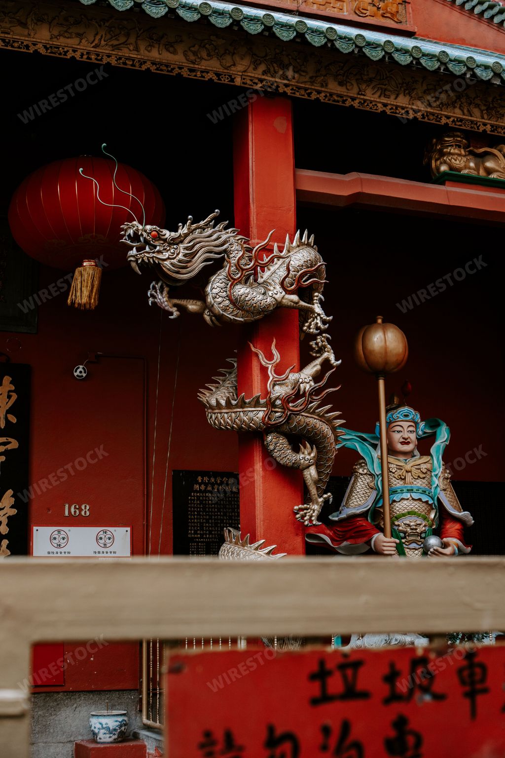 A vertical shot of a Red Chinese dragon on a Taoist temple in Chinatown Kuala Lumpur