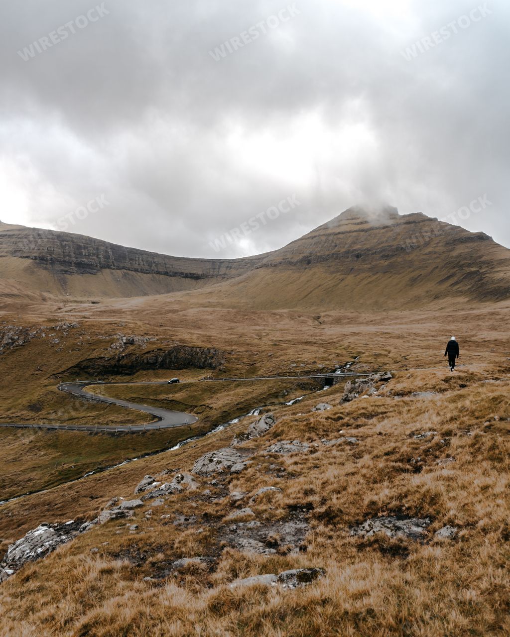 A beautiful vertical photo of a man against the background of a nature in Faroe Islands