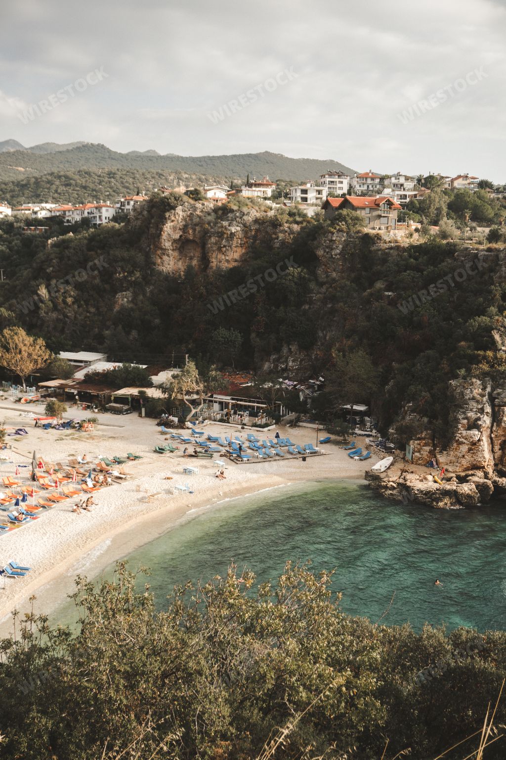 Mediterranean coast with turquoise water. Sunny Mediterranean beach in Kas, Turkey. Big Pebble Beach, Turkish Mediterranean