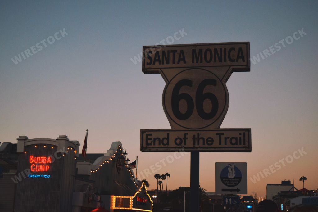 A closeup of the Route 66 End of the Trail Sign in Santa Monica, California during a sunset