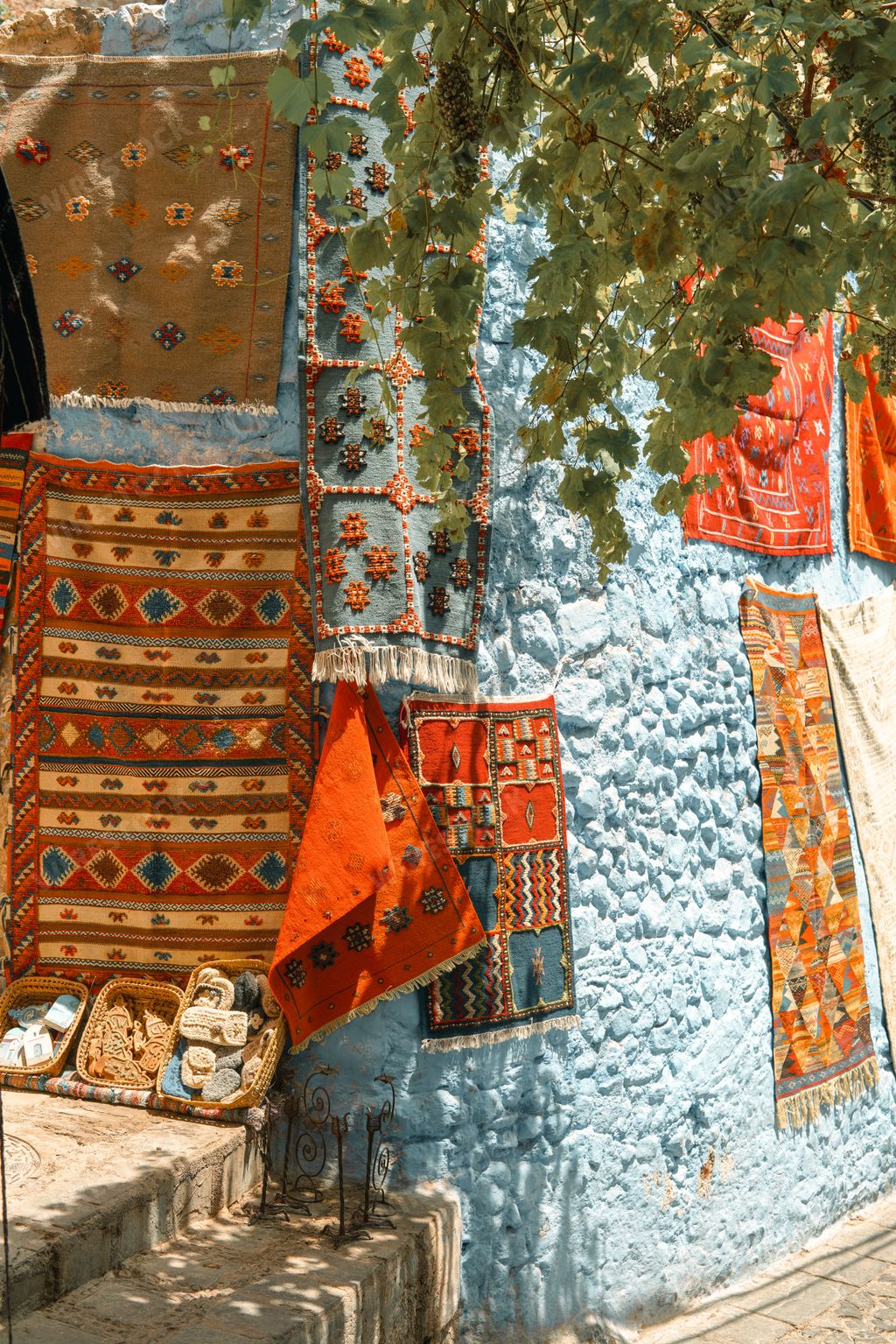A narrow alley between beautiful blue-washed buildings in Chefchaouen, Morocco