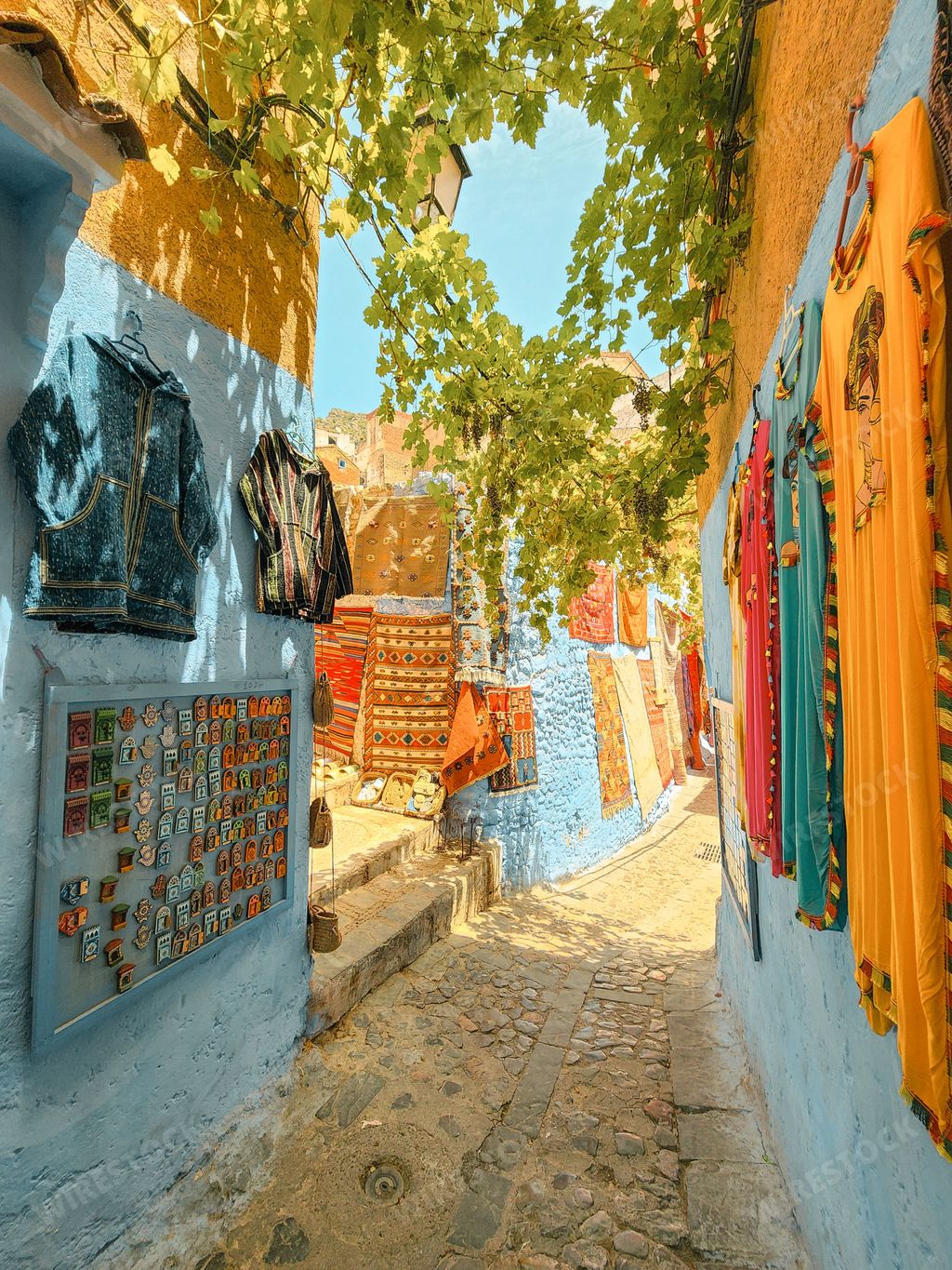 A narrow alley between beautiful blue-washed buildings in Chefchaouen, Morocco