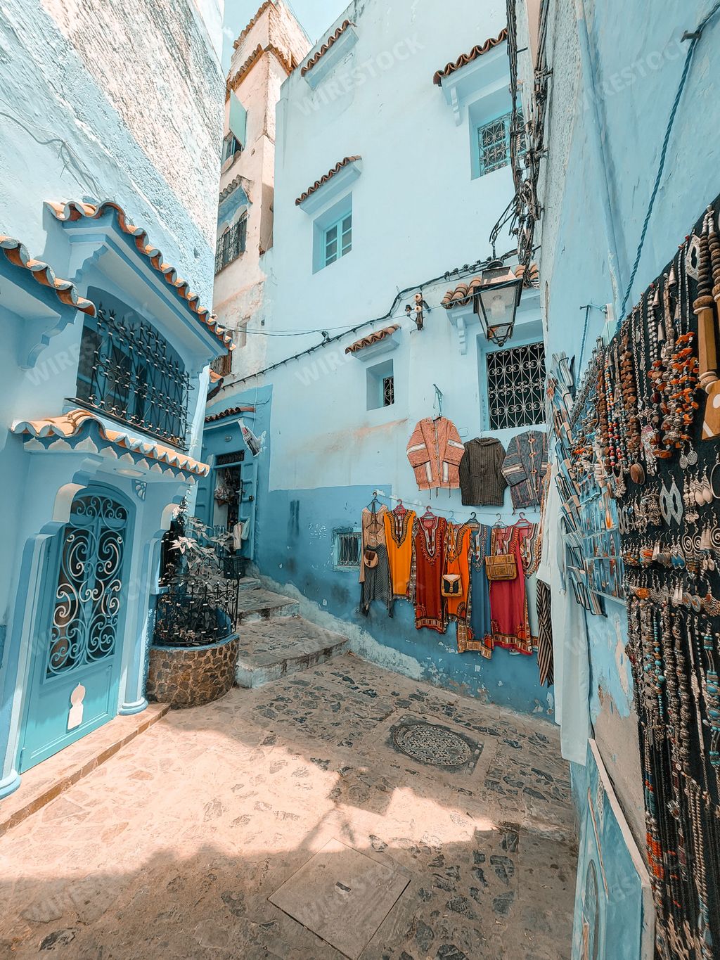 A narrow alley between beautiful blue-washed buildings in Chefchaouen, Morocco