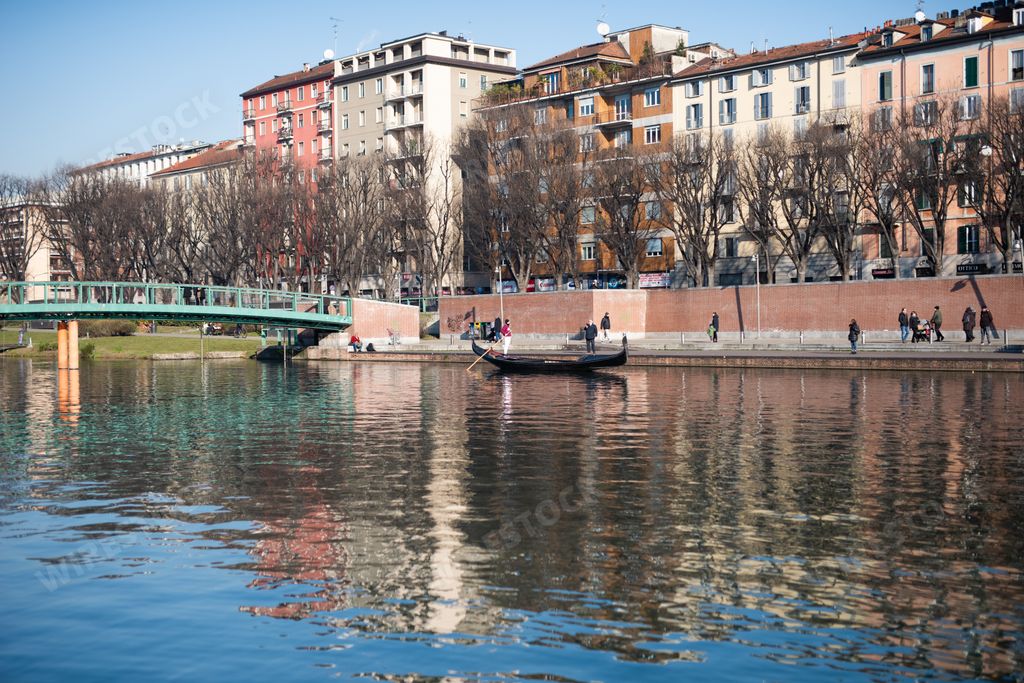 A landscape shot of gondola of venice in navigli district of milan italy in a clear sunny blue sky