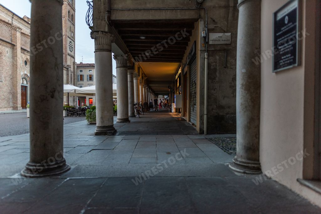 historic center of Crema in province of cremonacon church of center in background and the arcades visible