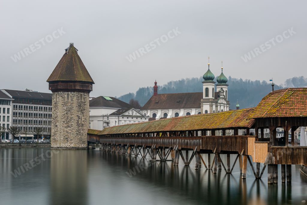 The Lucerne Jesuit Church surrounded by water under a cloudy sky in Lucerne in Switzerland