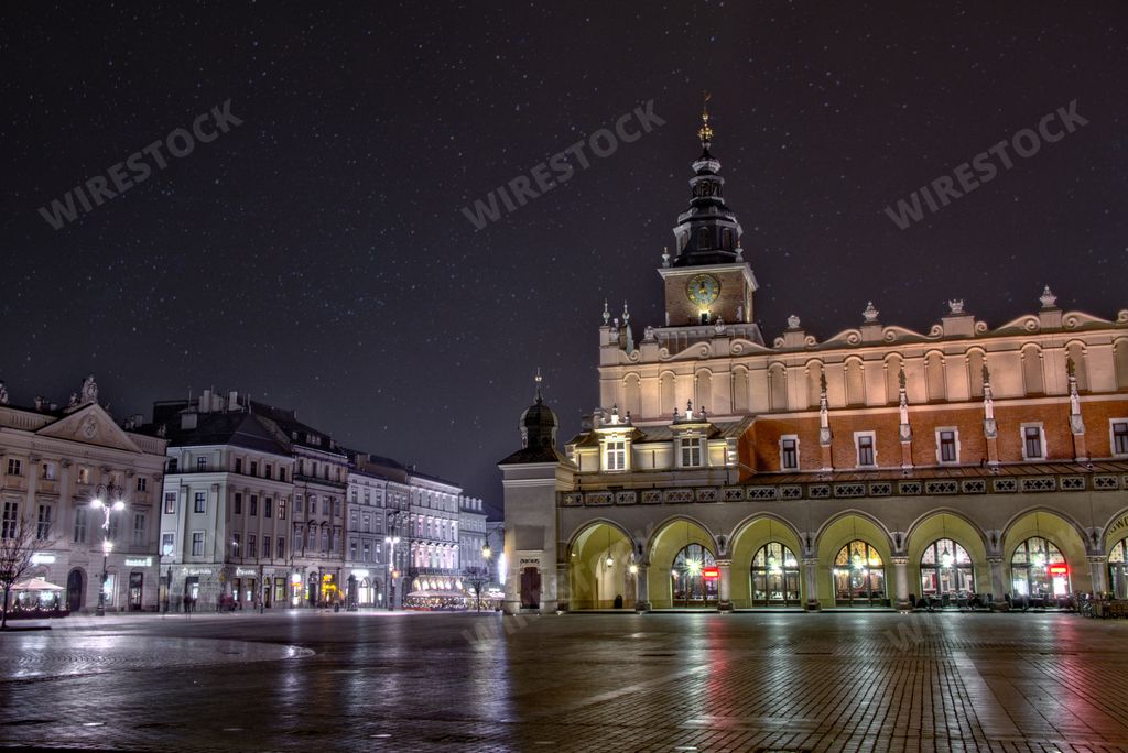 A wide shot of Main Market Square with the tall Town Hall Tower visible in Krakow, Poland
