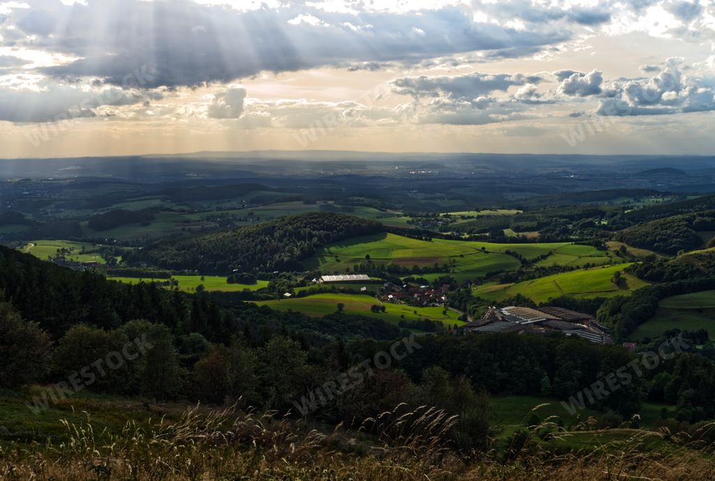 A beautiful mountainous landscape with greenery under a cloudy sky in Germany