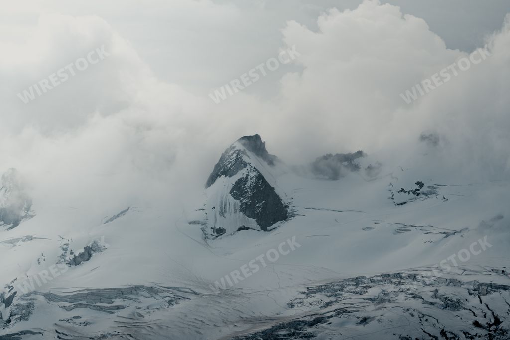 A snowy mountain in the clouds