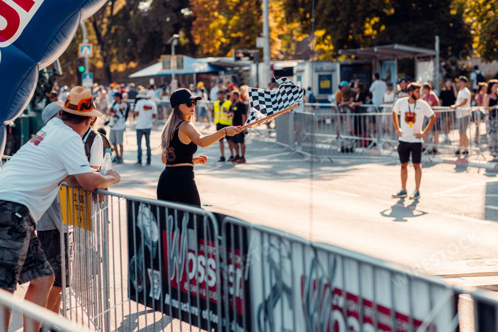 A beautiful woman holding a racing flag at the Red Bull Romanaics prologue street races in Sibiu
