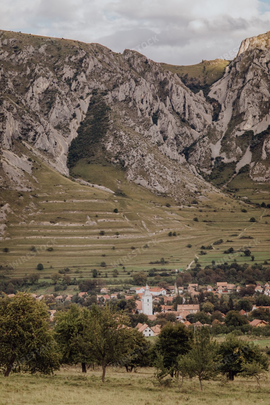 A scenic view of Rimetea village and Piatra Secuiului (Rock of the Szeklers) in Romania