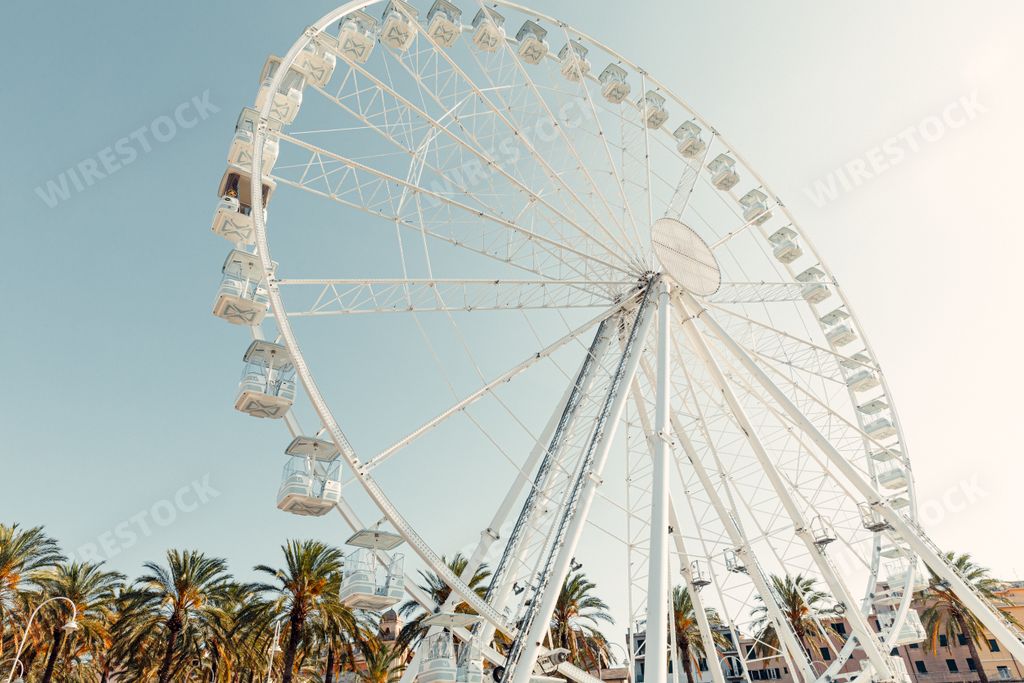 The Ferris wheel in Genoa, Italy with blue sky on the background