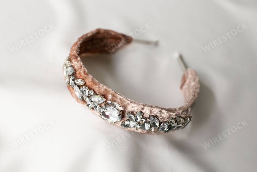 A closeup shot of a fancy headband with gems on white background