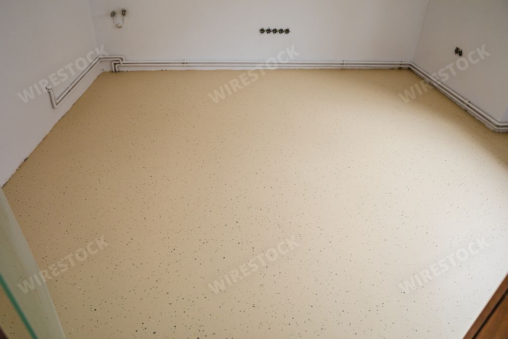A beige speckled floor of an empty room