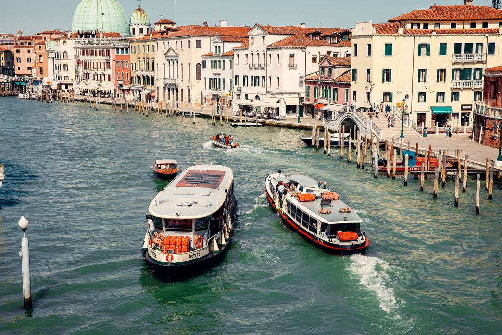A picturesque scene of boats gently floating in a canal surrounded by historical buildings