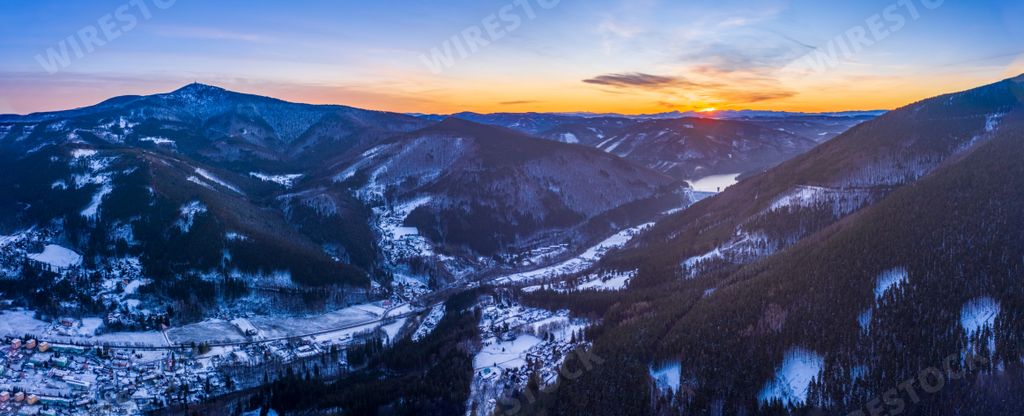A panoramic shot of the Lysa Hora and Smrk mountains during sunrise