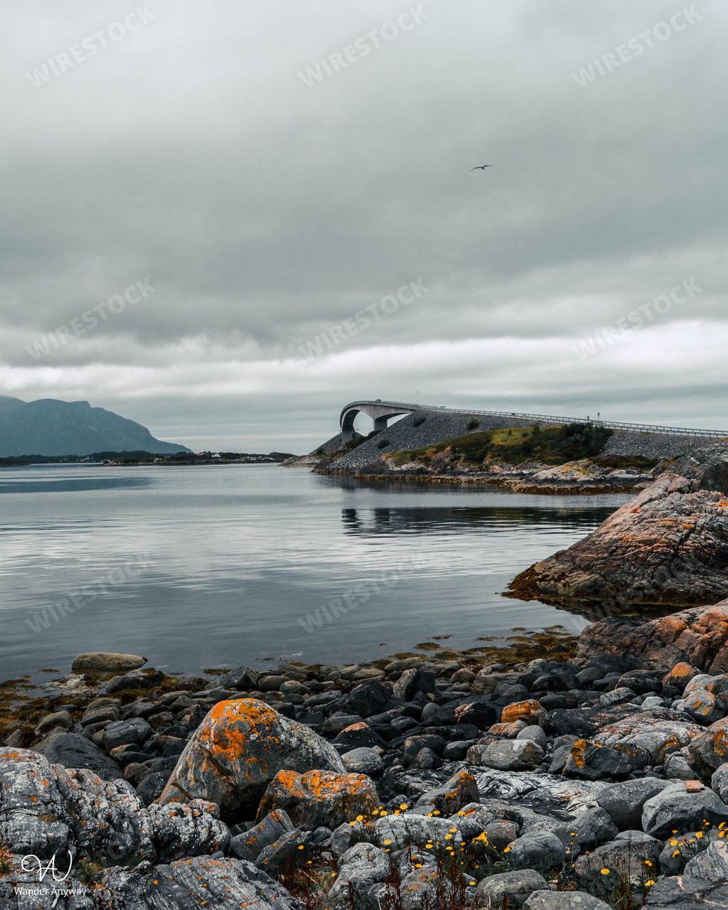 A vertical shot of the beautiful Storseisundet Bridge with a cloudy sky in the background in Norway