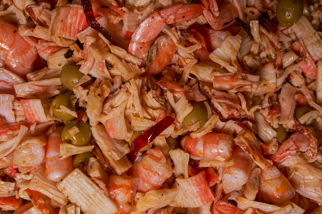 Shrimp and fish ceviche with surimi stewed with olives and peppers