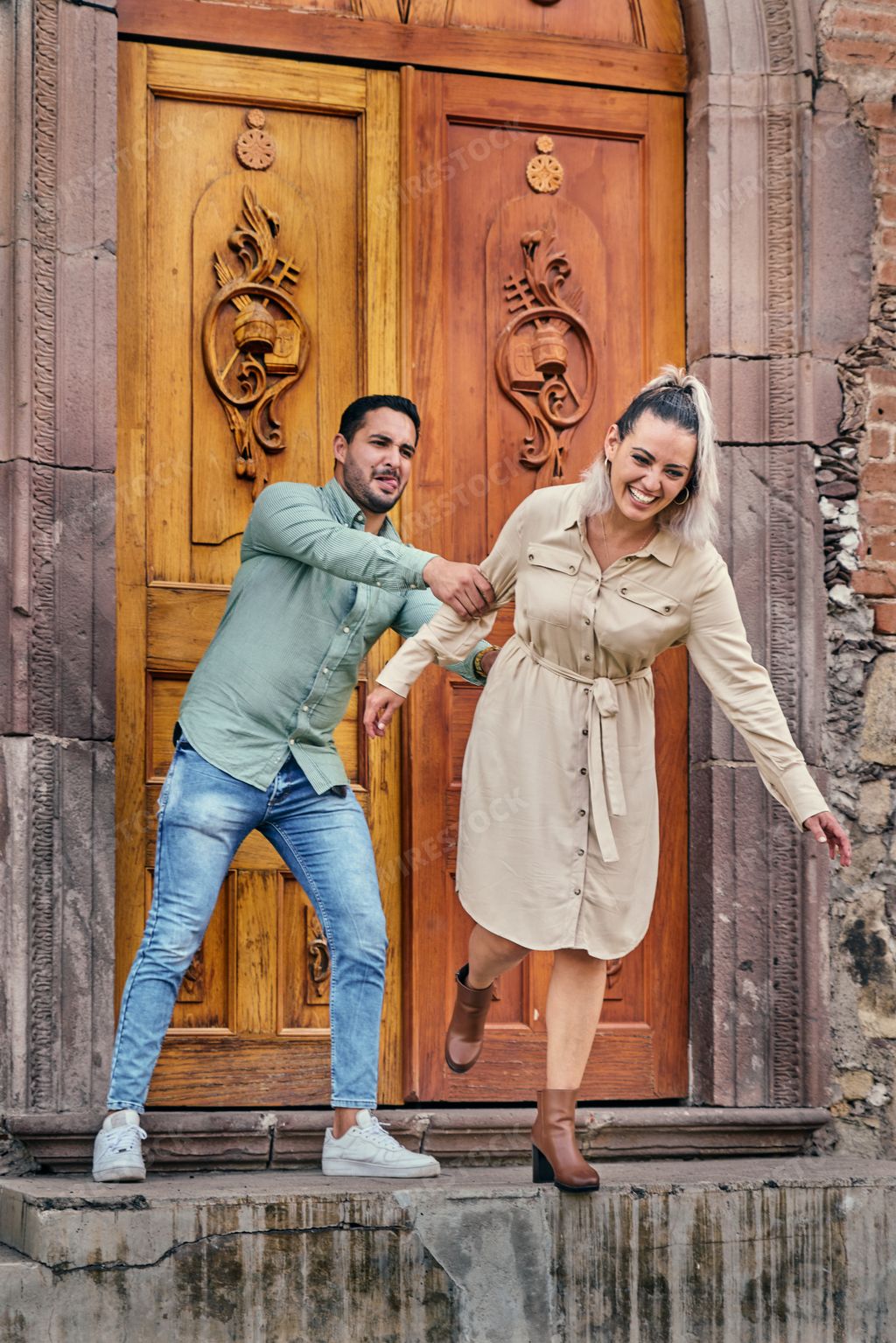 Young Latino male and female couple looking at each other in love between 25 and 35 years old