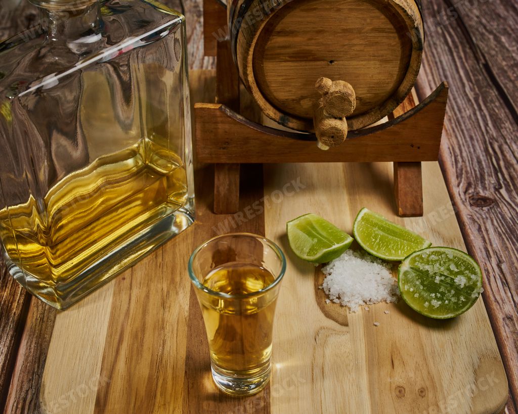 How to take a shot of tequila in Mexico with your lemon and salt with the tequila bottle and a wooden barrel