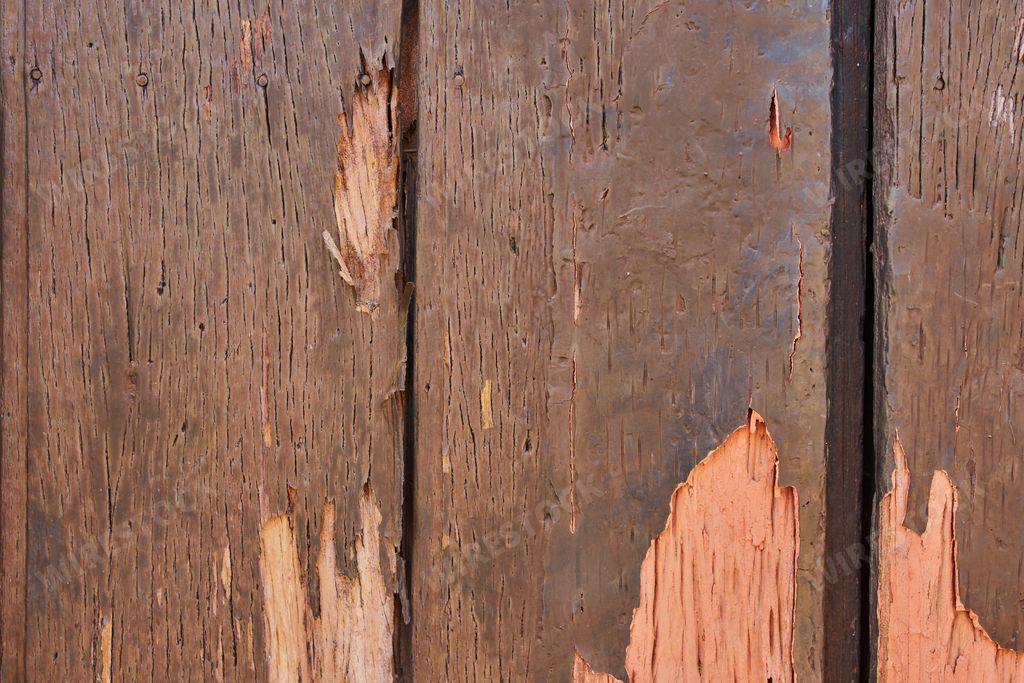Old wooden texture of windows and doors weathered by time with cracks and rusty nails