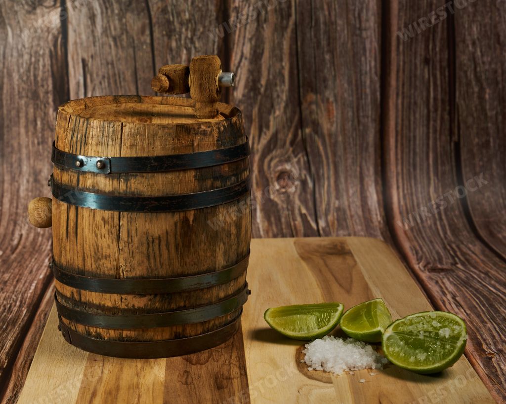 How to take a shot of tequila in Mexico with your lemon and salt with the tequila bottle and a wooden barrel