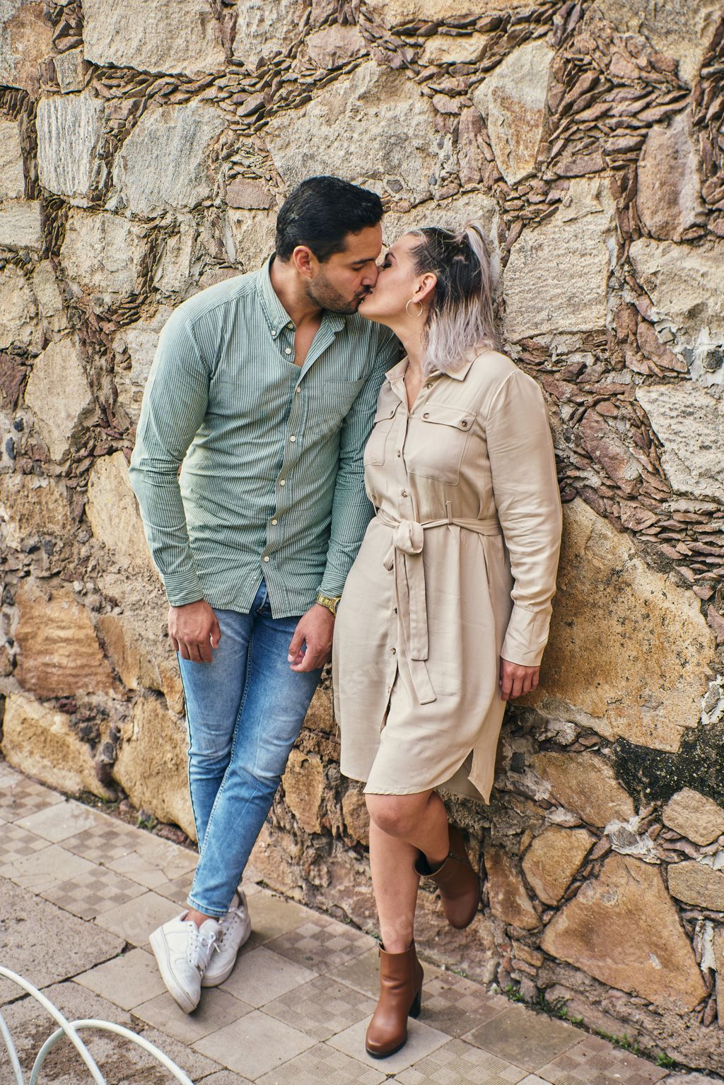 Young latin male and female couple in love kissing between 25 and 35 years old